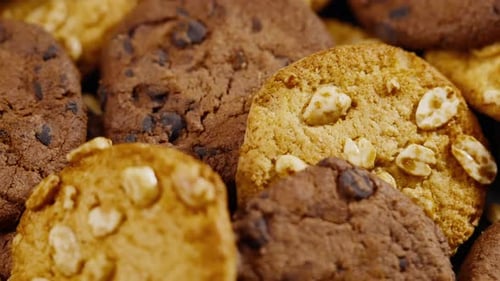 Close Up on Black and Blue Background Flat Plate with Cookie Cookies Lying Chaotically on the Table