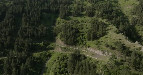 Dirigindo um carro em uma estrada de montanha com uma paisagem natural pitoresca na Geórgia. aéreo, câmera lenta