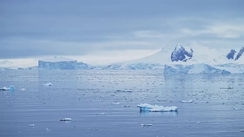 Massive Flat Top Icebergs Floating In The Calm Antarctic Ocean