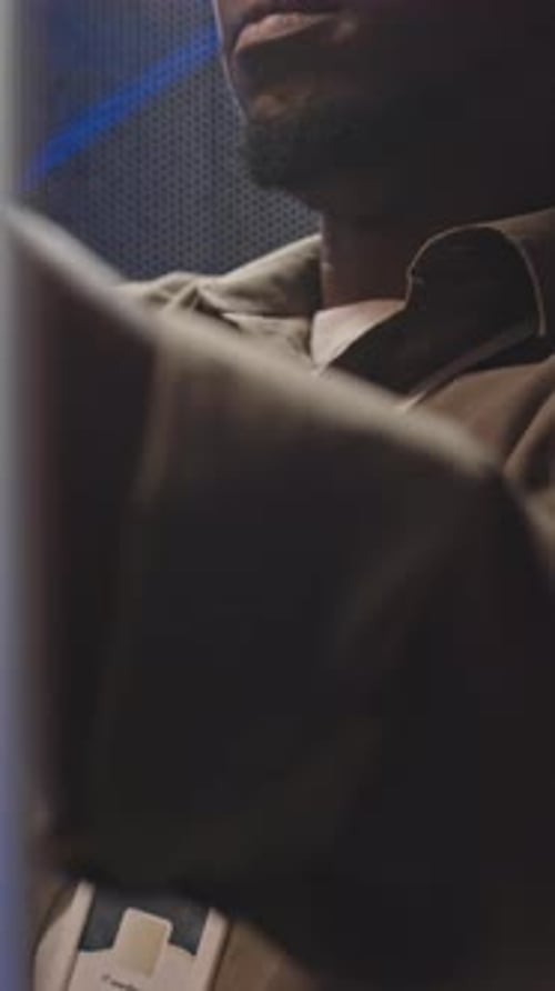 Man Working in Dark Server Room