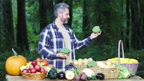 Gray-Haired Man with Harvest of Fresh Vegetables