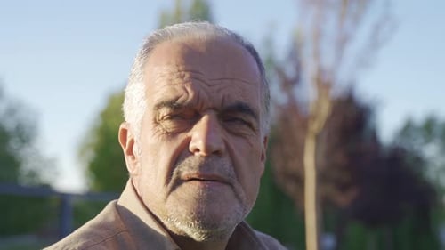 Senior Man Gazing into Distance on Sunny Day