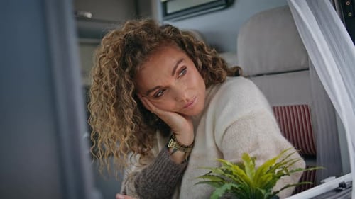 Tranquil Woman Dreaming Window Camper Van Looking Mobile Phone Close Up