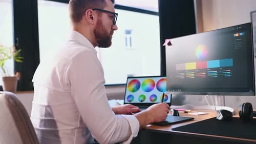 Graphic Designer Working with Digital Tablet in Office