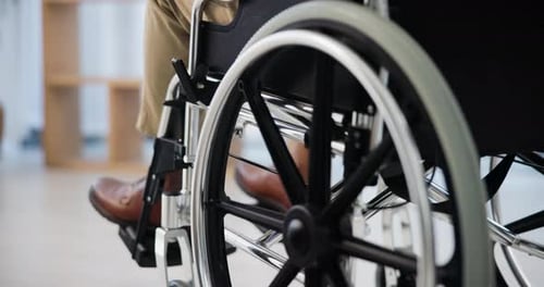 Wheelchair Moving Slowly in a Bright Room