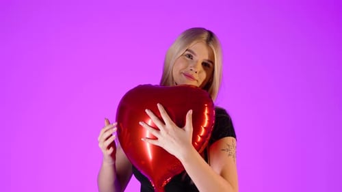 Concept someone gives his heart to a woman, hugging in love, studio shot