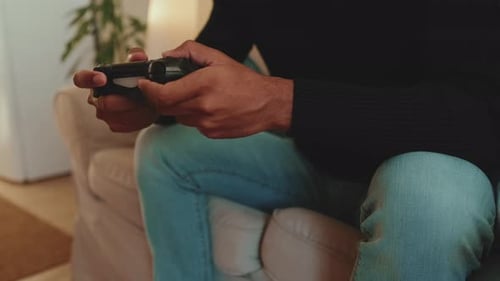 Close-up of young man's hands gamepads playing video game