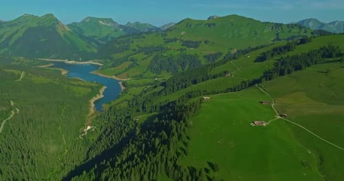 Dam and Reservoir Lake in Swiss Alps Mountains Feeding Hydropower Electric Power Plant to Produce