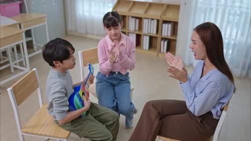 Teacher Instructing Children with Ukulele in Classroom