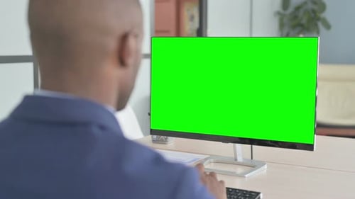 Young African Businessman Working on Computer with Green Screen