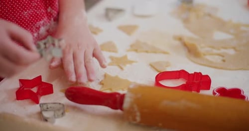 Child Making Cookies with Cookie Cutters