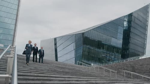 Executive Managers Going Downstairs in Financial District of City after Work