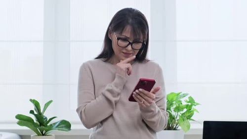 Woman Uses Smartphone Indoors During Daytime