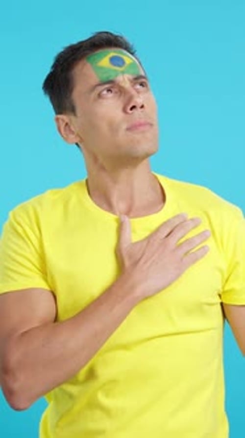 Man Puts Hand On Heart With Painted Flag