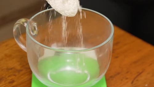 Measuring flour into transparent cup for cooking ingredient