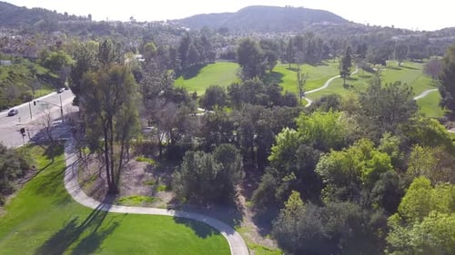 4K Aerial View of Golf Course With Breathtaking Mountains and Rolling Hills in the background in Los