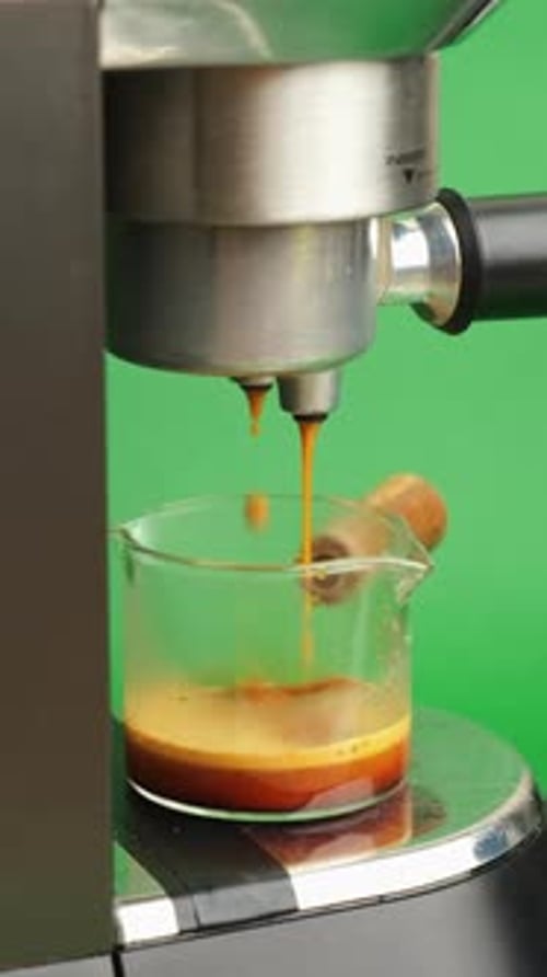 Detailed Macro Image Depicting Hot Espresso Droplets Hitting Glass With Vibrant Tones