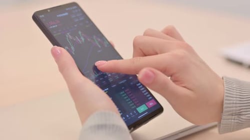 Close up of Woman Trading in Stock Market on Smartphone