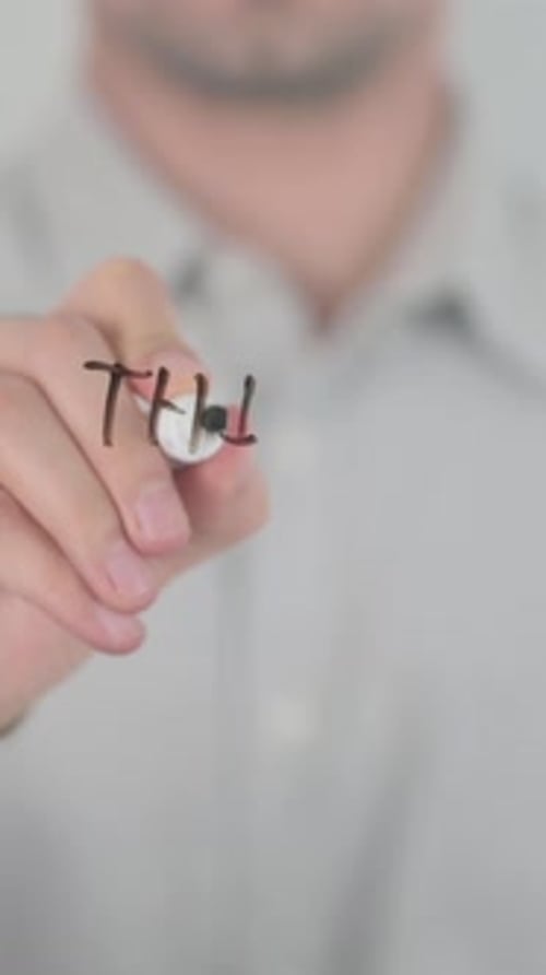Man Writes Think Different on Glass Surface with Marker