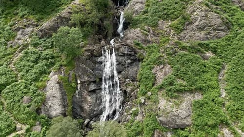 Scenic Waterfall Cascading Down a Rocky Mountain