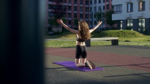 Woman Kneeling on Yoga Mat Reaching Upward