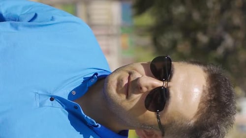 Vertical Video of Depressed man goes for a walk in the park.