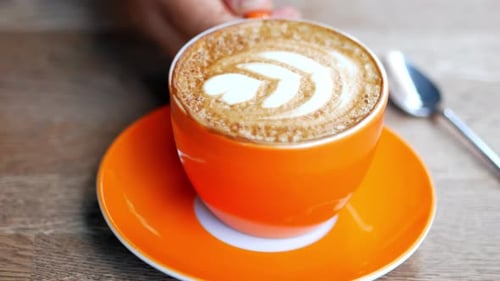 Close Up of Latte in Orange Cup