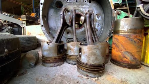 Large piston on the floor of a workshop