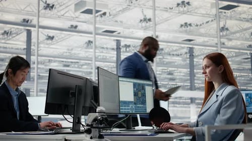 Man and Woman Review Microchip Production Operations Inside Factory