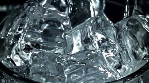Water Pouring Over Ice Cubes Macro Close Up