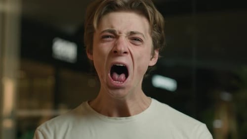 Young Adult Man Expressing Extreme Anger Close Up