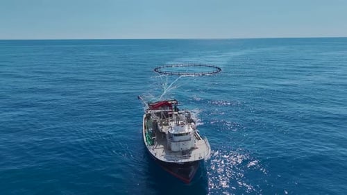 Aerial View Floating Pens of a Fish Farm are Replenished with Oxygen As a Ship Carefully Navigates