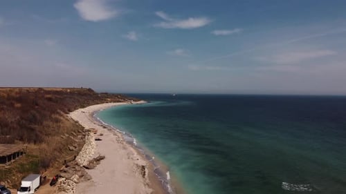 Aerial View Of Sandy Beach And Turquoise Water. Seagull Flying Over