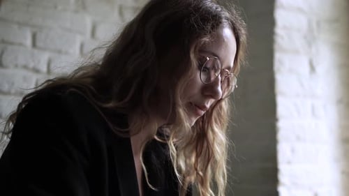 Young Woman Working on Her Laptop Computer in Coffee Shop