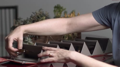 Woman Takes Sunglasses From Designer Carrier