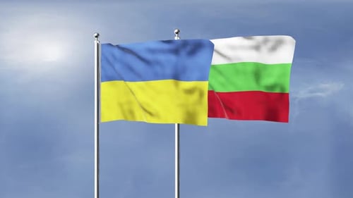 Waving Flags of Ukraine and Bulgaria Against a Blue Sky