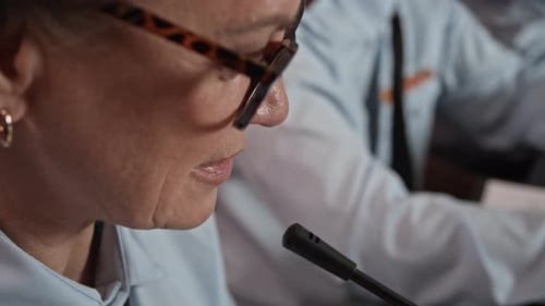 Person Speaking Into Microphone at Conference