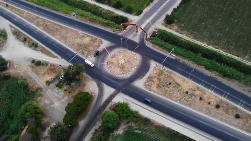 drone view of highway passing near farmland