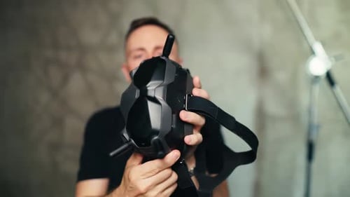 Man Holding Black Drone Goggles Close Up