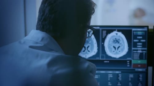 In Medical Laboratory Patient Undergoes MRI or CT Scan Process, in Control Room Doctor Watches Proc