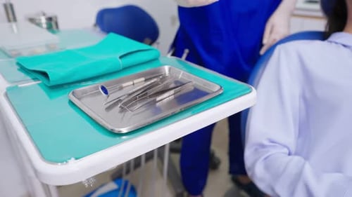 Close up hands of Female dentist examine tooth at dental health clinic.
