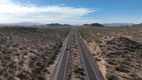 Aerial view of desert landscape with road and truck, United States.