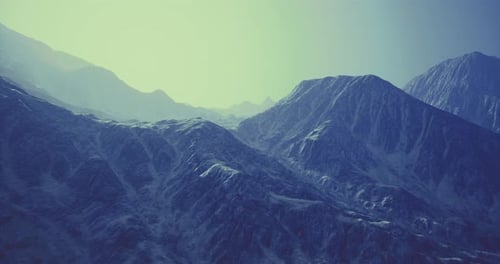 Majestic Mountain Landscape with Blue Hues and Distant Peaks at Twilight