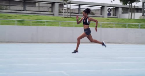 Woman Runs on Track for Fitness Training