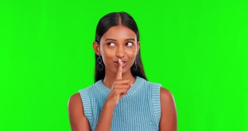 Green screen, face of woman and secret of finger on lips for privacy, mystery or noise in studio