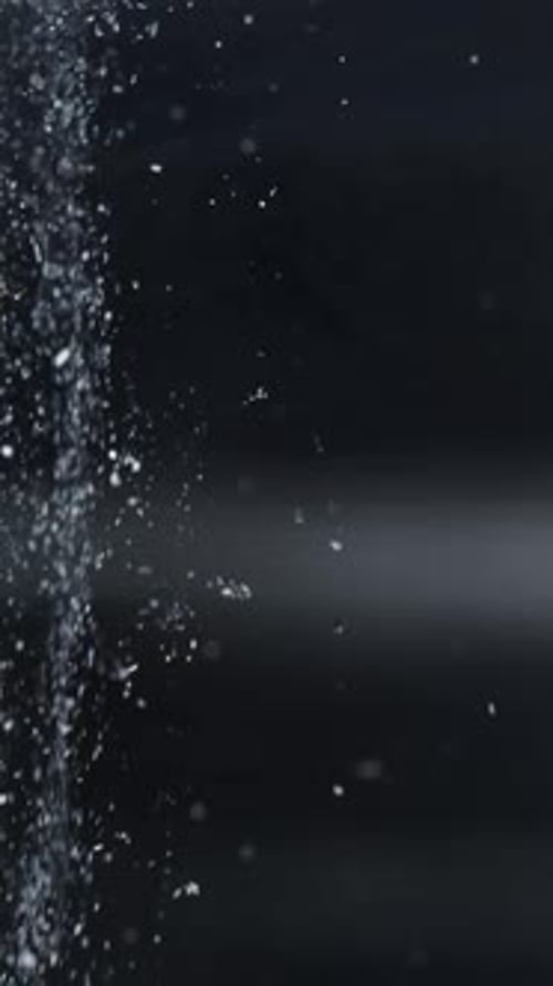 Water Spraying on Dark Background