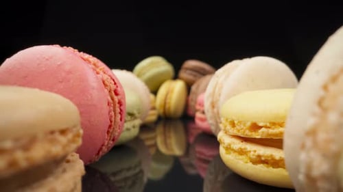 Colorful Macarons Reflect on Black Surface