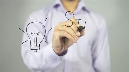 Drawing Lightbulb and Writing Startup Idea