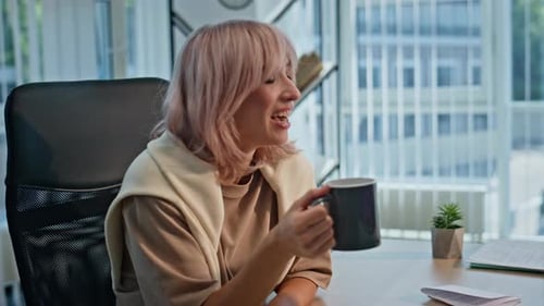 Smiling Young Adults Video Conferencing in Modern Office
