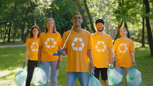 Portrait Of The Multiethnic Group Of The Eco Activists Standing In The Park After Cleaning The